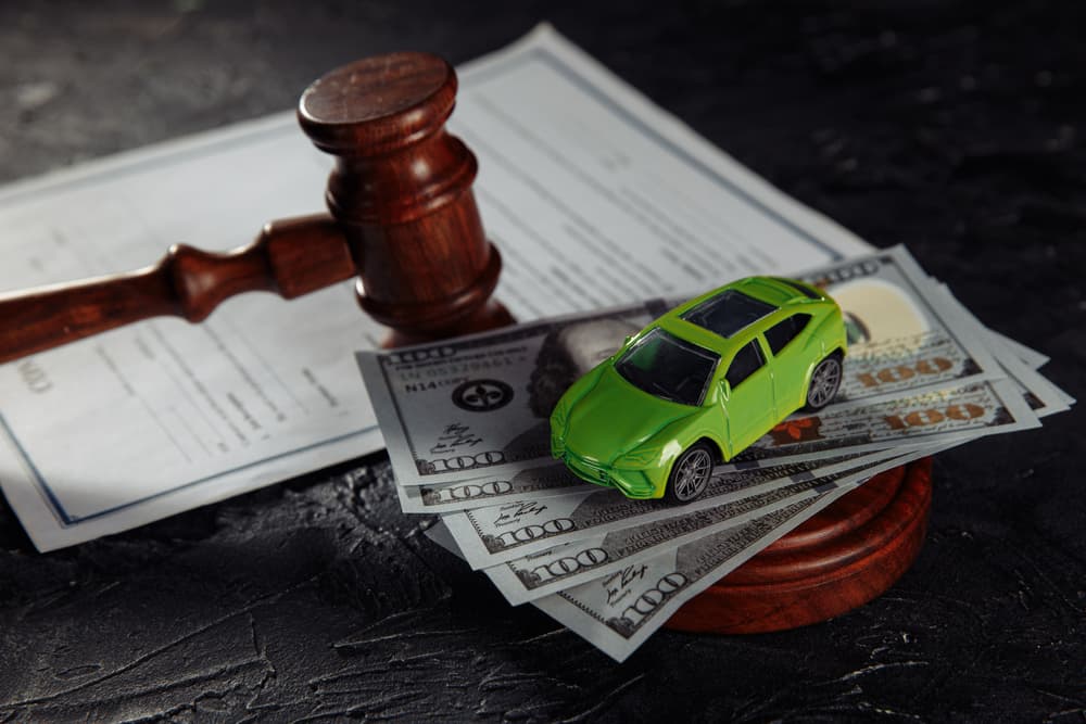 Judge's gavel, Money and model of car on the table