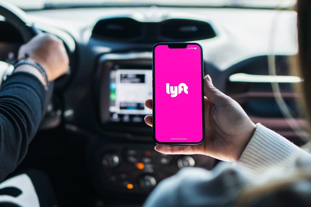 A passenger in car using Lyft rideshare application
