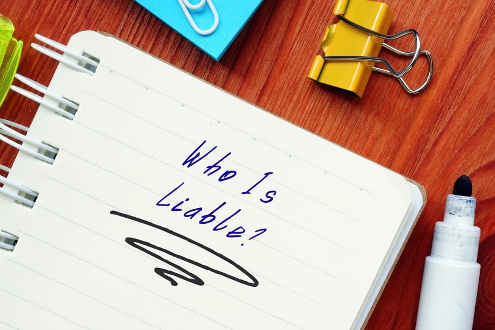 Who Is Liable? with inscription on the page