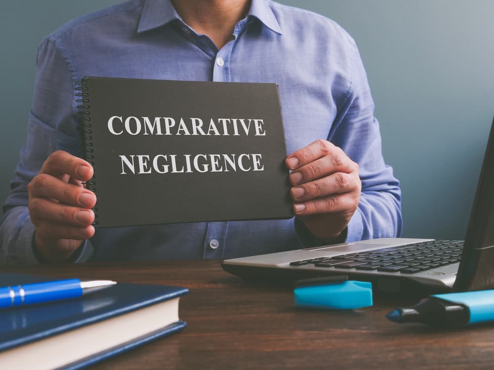Man shows Comparative negligence data in the book.