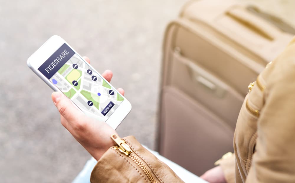 Woman using rideshare app. Ride share application in mobile phone.