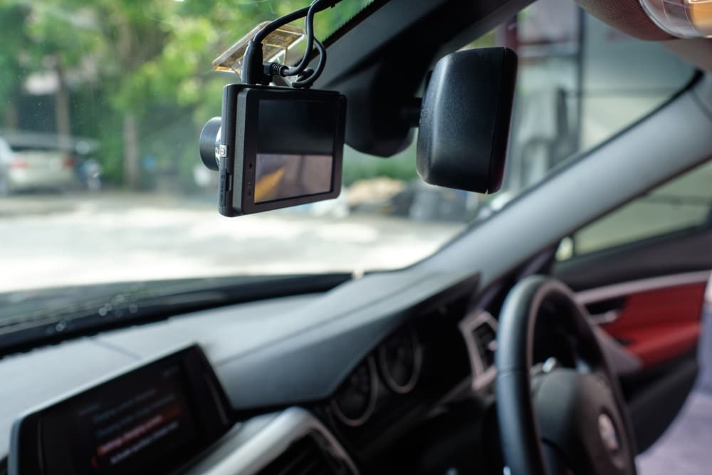 Onboard car camera mounted on windshield to record driving and road incidents.